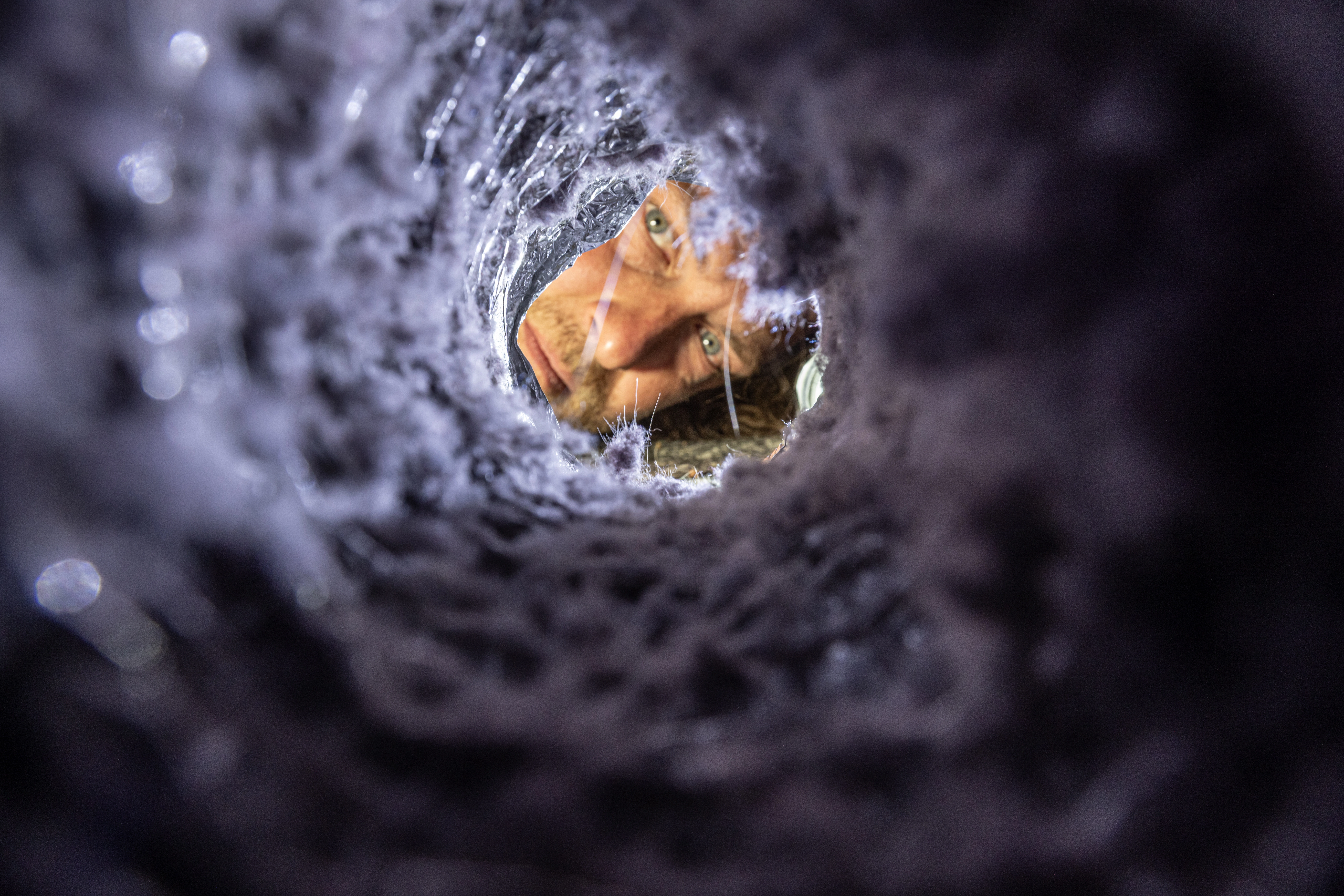 Technician cleaning a dryer vent